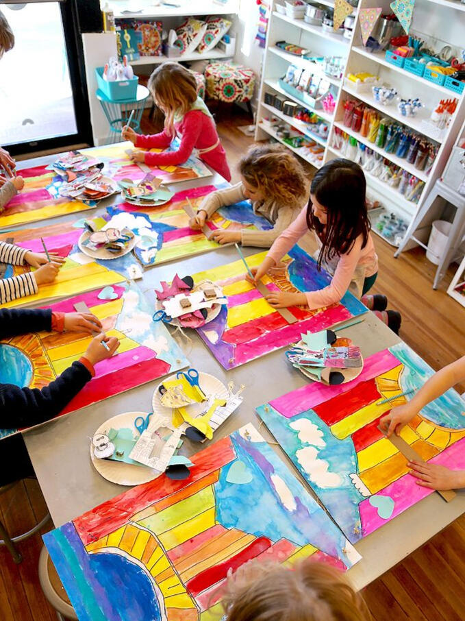 Homeschool Art Group Painting Together Small group of children painting on a table for an in-home homeschool art session.